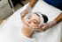 Instructor demonstrating advanced facial aesthetics techniques during training