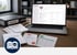 Dokumente wie Notfallpläne und Richtlinien werden von einem Schreibtisch in eine Software auf einem Laptop digitalisiert - Software für Alarmierung - Notfall- und Krisenmanager (NKM®).