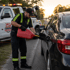 Towing Deltona fuel delivery service refueling a stranded car on the roadside during sunset