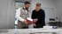 Christian und Fabian Roßmann studieren die VOB-Verordnung für Bauunternehmer.