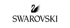 Schwarzer Swarovski-Schriftzug mit einem schwarzen Schwanen-Logo darüber auf dunkelgrünem Hintergrund.