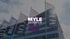 Gebäude mit Fahnen und dem Logo "MYLE MESSEFILM" in der Bildmitte.