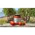 Gustama 100% Apulian Passata Tomato Puree jar with fresh tomatoes on a rustic wooden table in a tomato field.