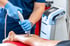 Medical professional performing shockwave therapy on a patient's lower leg.