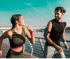 Two people jogging by the water, energized thanks to BHRT therapy.
