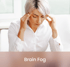 Middle-aged woman experiencing brain fog and difficulty concentrating, a common symptom treated with functional medicine.