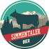 Circular logo with a cow, mountains, and trees, with "SIMMENTALER BIER" in red and white text.