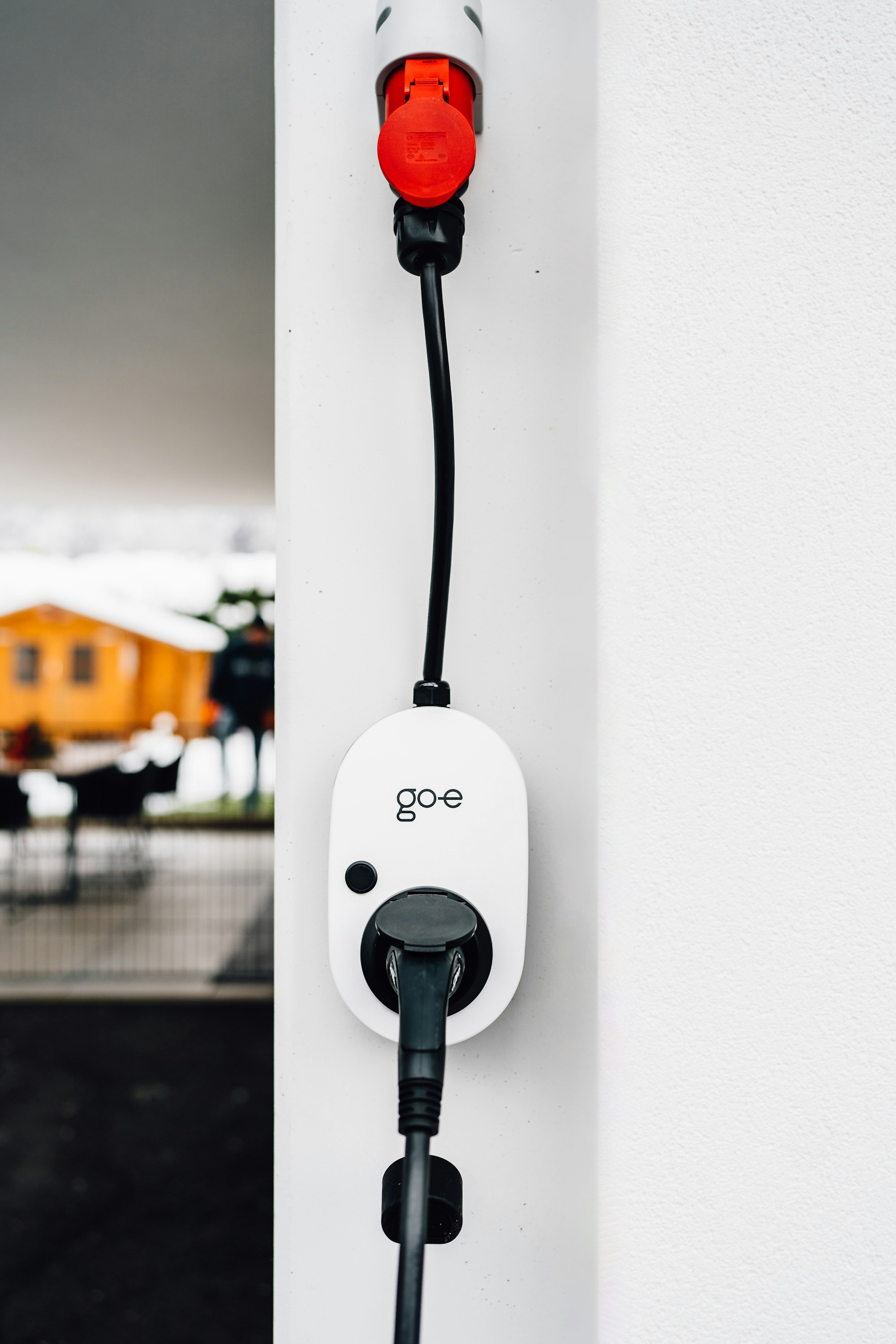 EV charging cable plugged into a wall-mounted charger