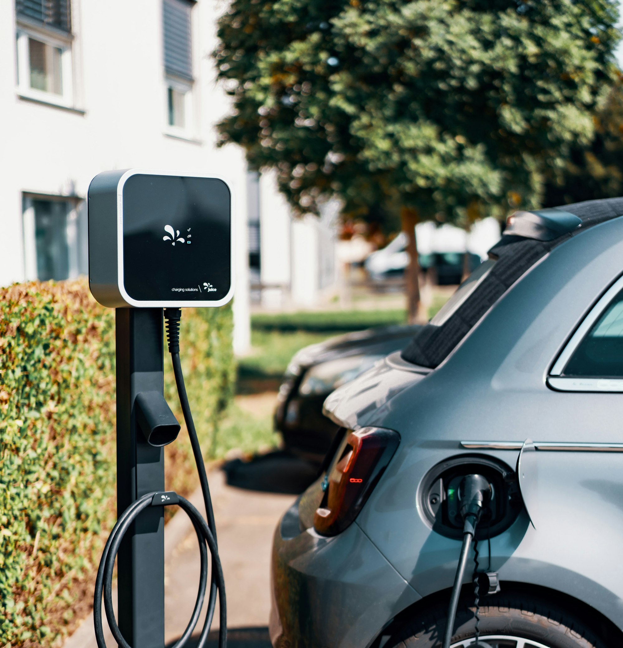 Electric vehicle connected to a shared-parking charging station