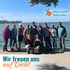 Gruppe von 11 Personen vor einem See mit blauem Himmel, Logo "physio team heike faller", Text "Wir freuen uns auf Dich!"