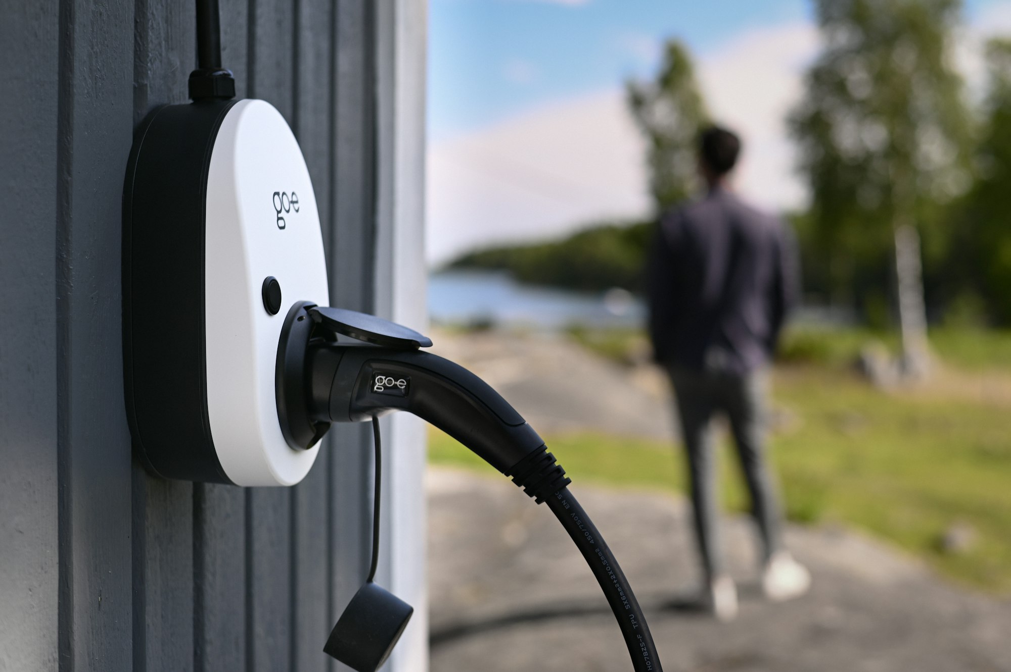 EV charging connector plugged into a vehicle outdoors