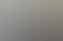 Ein Mann und eine Frau lächeln in die Kamera vor einer Wand mit Immobilienbildern und dem Text „TOBIEN Immobilien“.