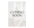 Text: COMING SOON auf verschwommenem Hintergrund eines Salons mit Stuhl und Blumen.