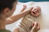 Mom helping her baby stop crying with colic treatment in Lincolnton