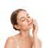 A woman with her eyes closed touches her face after a machine-assisted face massage