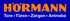 Blaues Logo mit orangefarbenem "HÖRMANN" und weißem "Tore • Türen • Zargen • Antriebe" darunter.