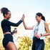 Two women high-fiving after Shockwave therapy, celebrating an active lifestyle