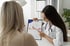 A dietitian or doctor discussing a chart with a patient.
