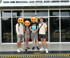 Four people standing in front of the Chon Buri Provincial Land Office, Bang Lamung Branch building.
