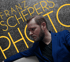 Porträt von Franz Schepers vor Schriftgrafik