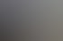 Ein Mann arbeitet am Schreibtisch an einem Curved Monitor mit Architektur-Visualisierungen von Gebäuden.