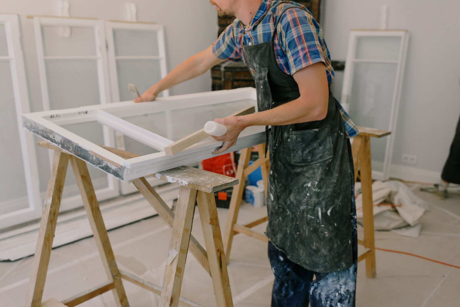 Window craftsman working at an open window frame
