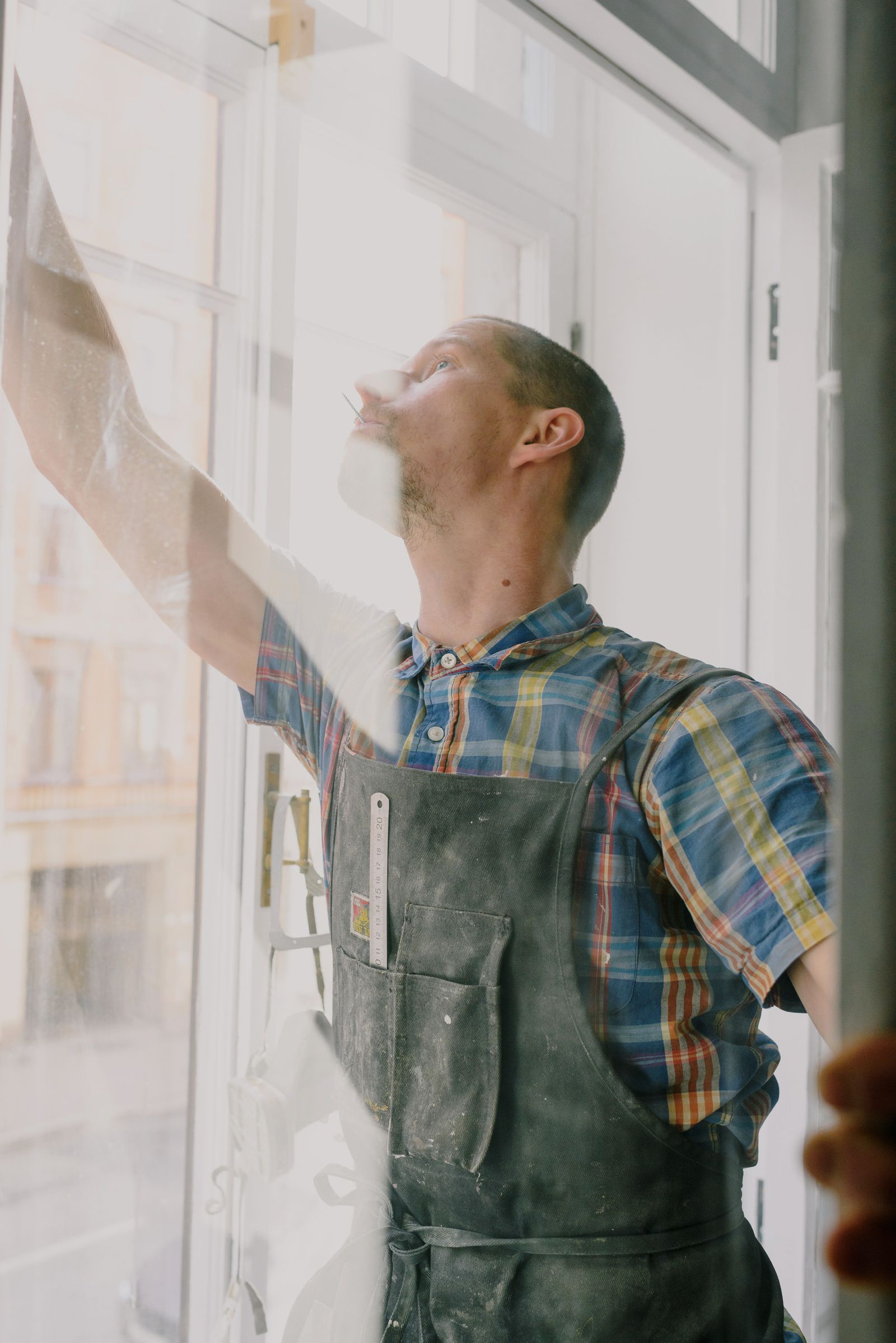 Insulated glass unit being handled during a glass-only window replacement