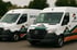 Zwei weiße Mercedes-Benz Transporter mit JM Entrümpelung-Logo und Schriftzug.