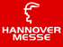 Logo der Hannover Messe: weißer stilisierter Kopf über "HANNOVER MESSE" auf rotem Hintergrund.