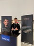 Amr Hassan am Amro Media Messestand mit Roll-ups für planbare Neukunden- und Mitarbeitergewinnung durch professionelle Videos.