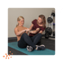 Practitioner assisting older woman with exercise