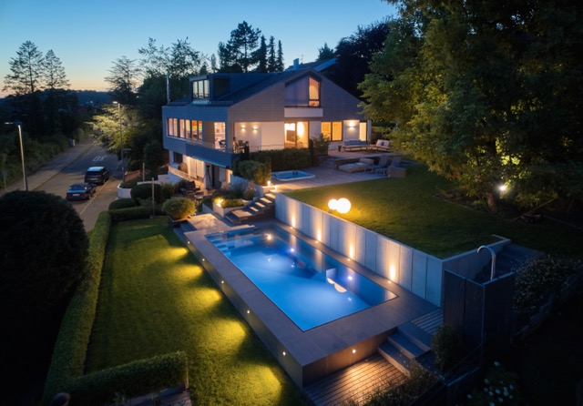 Geradlinige Poolanlage mit Naturstein und integrierter Sitzbank – Ansicht 3