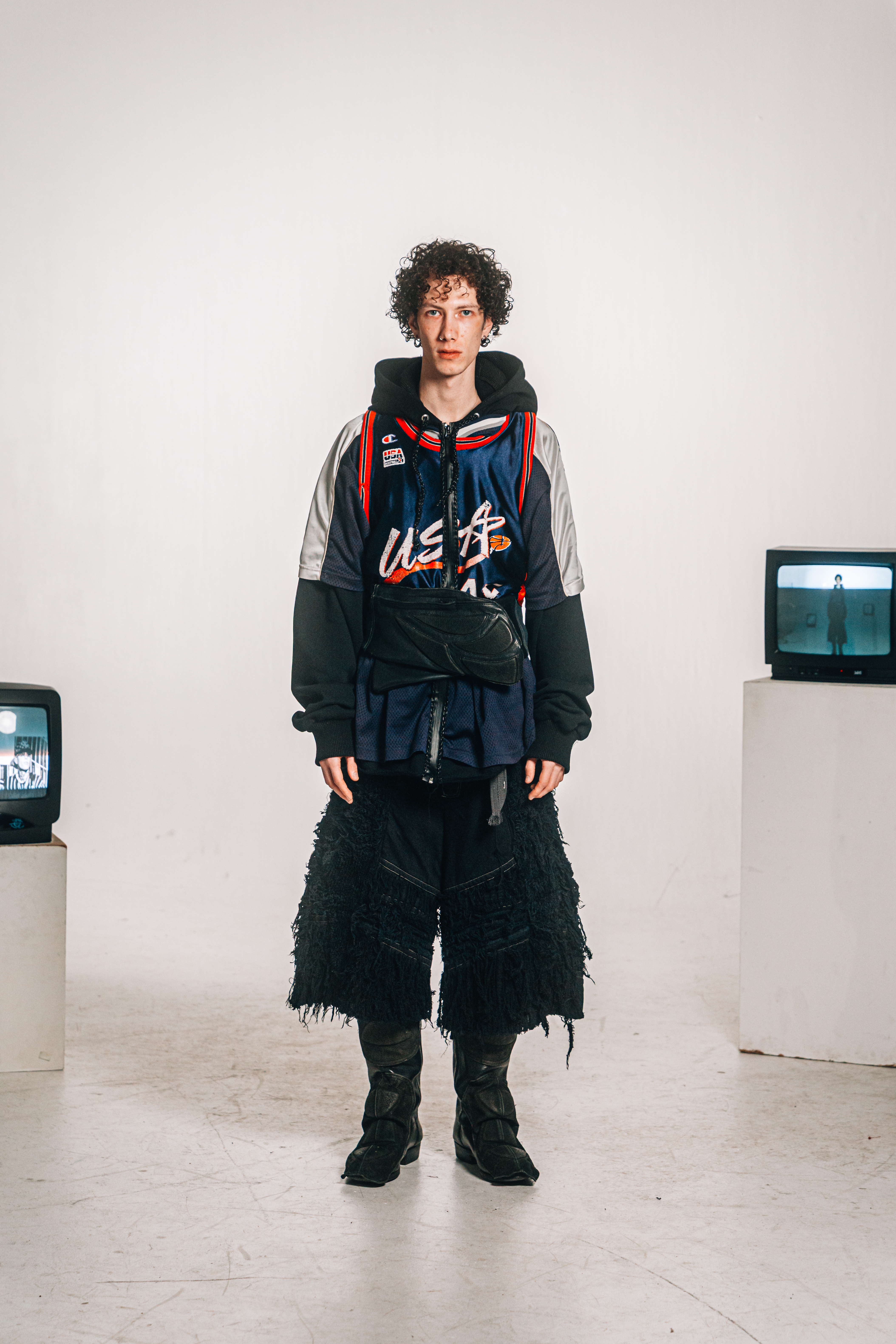 Distressed denim jorts and jersey hoodie with leather elements