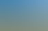 Sechs Personen posieren lachend auf drei Quads und zwei UTVs auf einem grasbewachsenen Berg unter blauem Himmel.