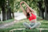 Young woman stretching outdoors, supporting arthritis pain relief and joint mobility