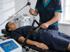 Therapist adjusts a patient's lumbar traction harness for spinal decompression