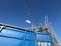 Kran hebt die verpackten Platten zum Container