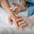Hand administers an injection into a hand during an exosome therapy session.