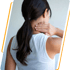 Woman in a white tank top rubs her neck, seeking neck pain relief.