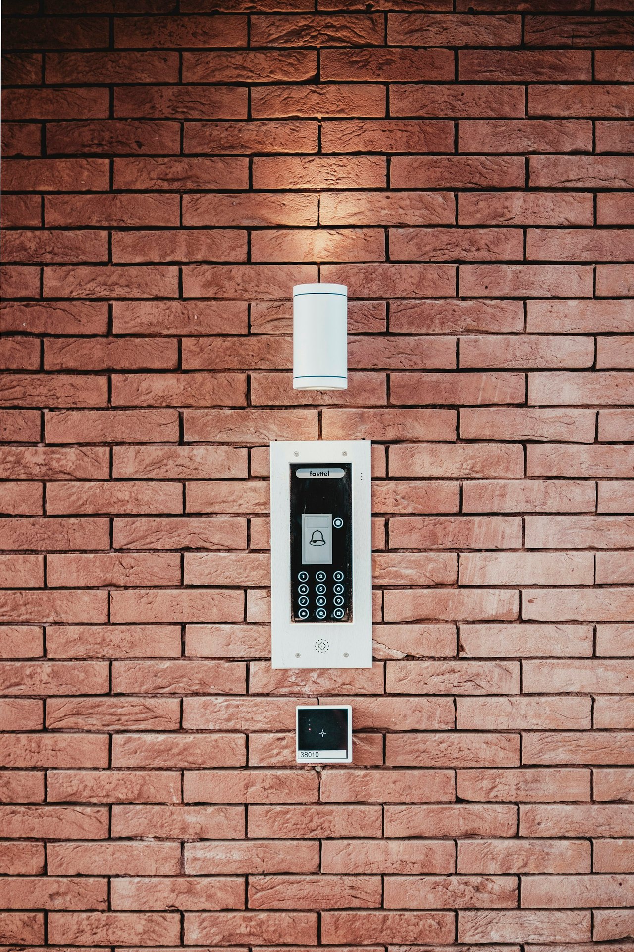 A home security keypad and control panel mounted on an interior wall