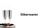 Zwei silberne Sektflöten auf einem Tablett mit Korken, daneben der Text "Silberwaren".