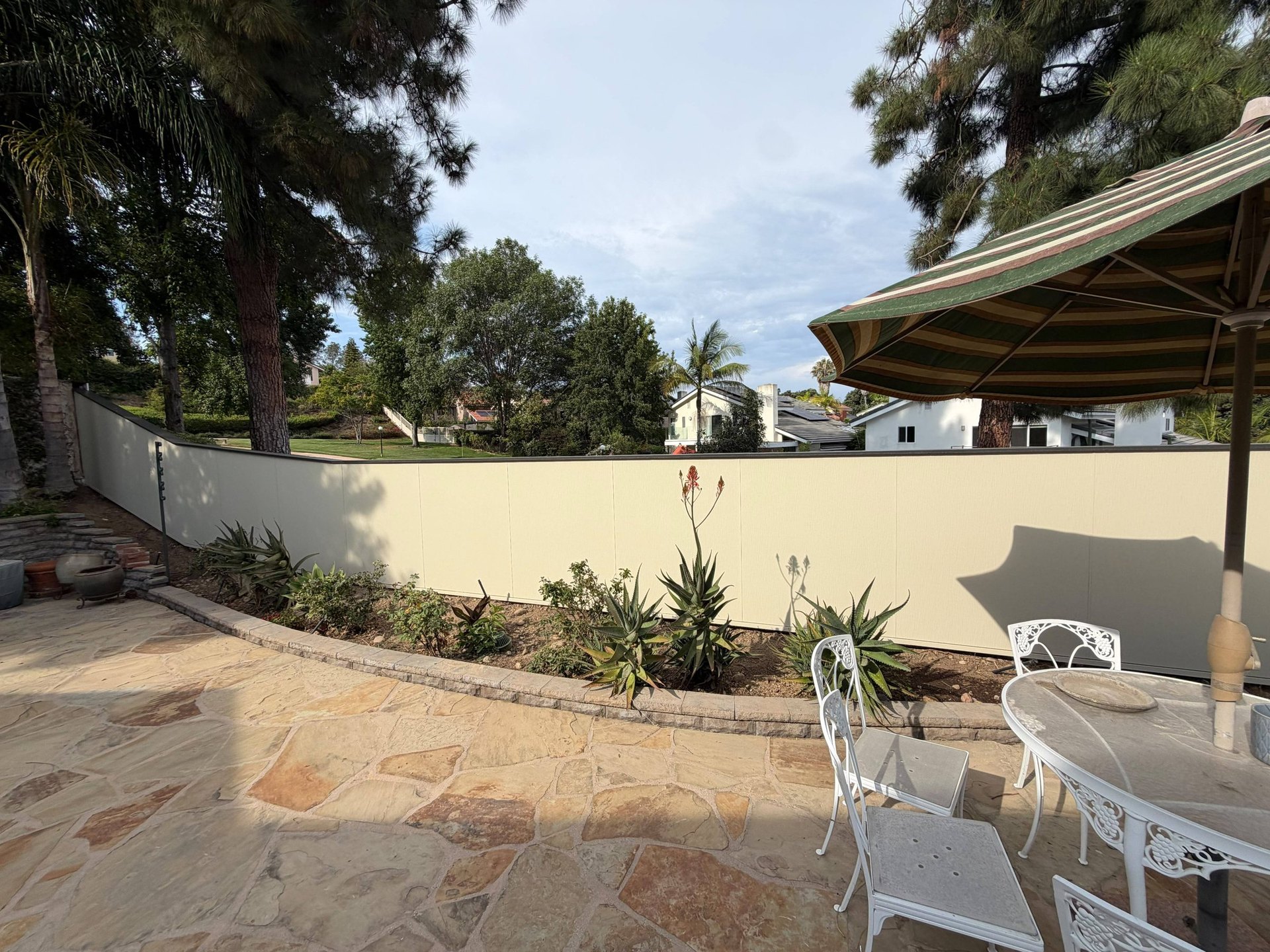 Backyard patio enclosed by a James Hardie Architectural Panel fence in San Diego