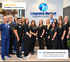 Integrated Medical Chiropractic & Wellness staff standing together under a 4.9-star review badge.