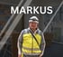 Mann mit Schutzhelm und Warnweste lächelt, im Hintergrund unscharfer Raum, Text "MARKUS" oben.