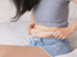 Woman pinches stomach fat, feeling the need for metabolic health support.
