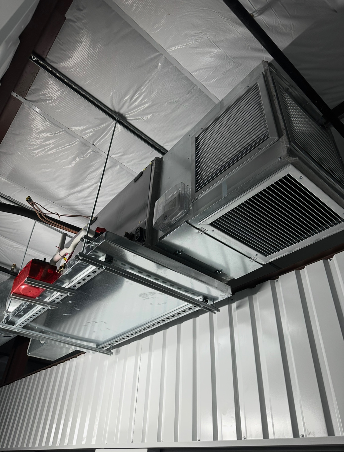 Ceiling suspended commercial air handler mounted on steel unistrut framing