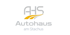 Logo von AHS Autohaus am Stachus mit grauem Text und gelb-orangefarbenen Kurven.