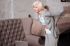 Elderly woman bending, holding her lower back.