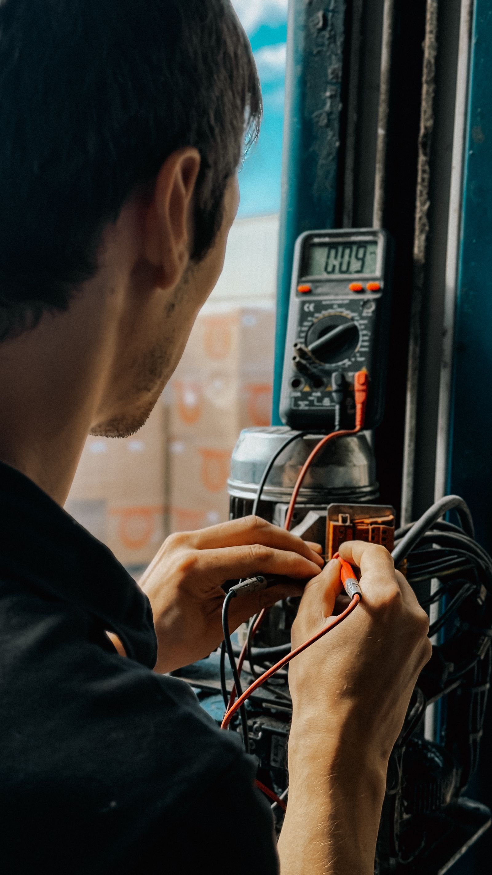 Electrician testing a circuit with a multimeter