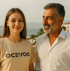 Junge Frau im beige-farbenen OCEVOO-T-Shirt und lächelnder Mann mit Bart.